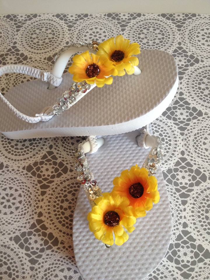 Toddler white flip flop topped with a sequence mesh and double sunflower