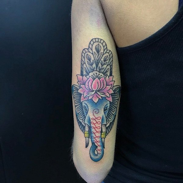 Hamsa tattoo with an elephant and a lilac flower.