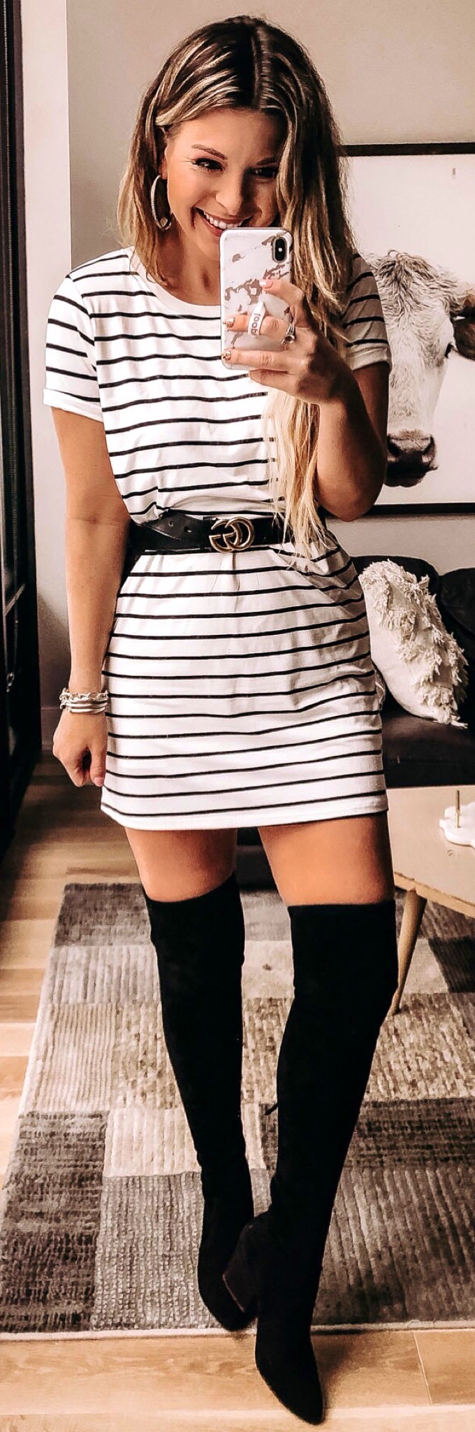 Knee length black boots with white and black striped short-sleeved dress.
