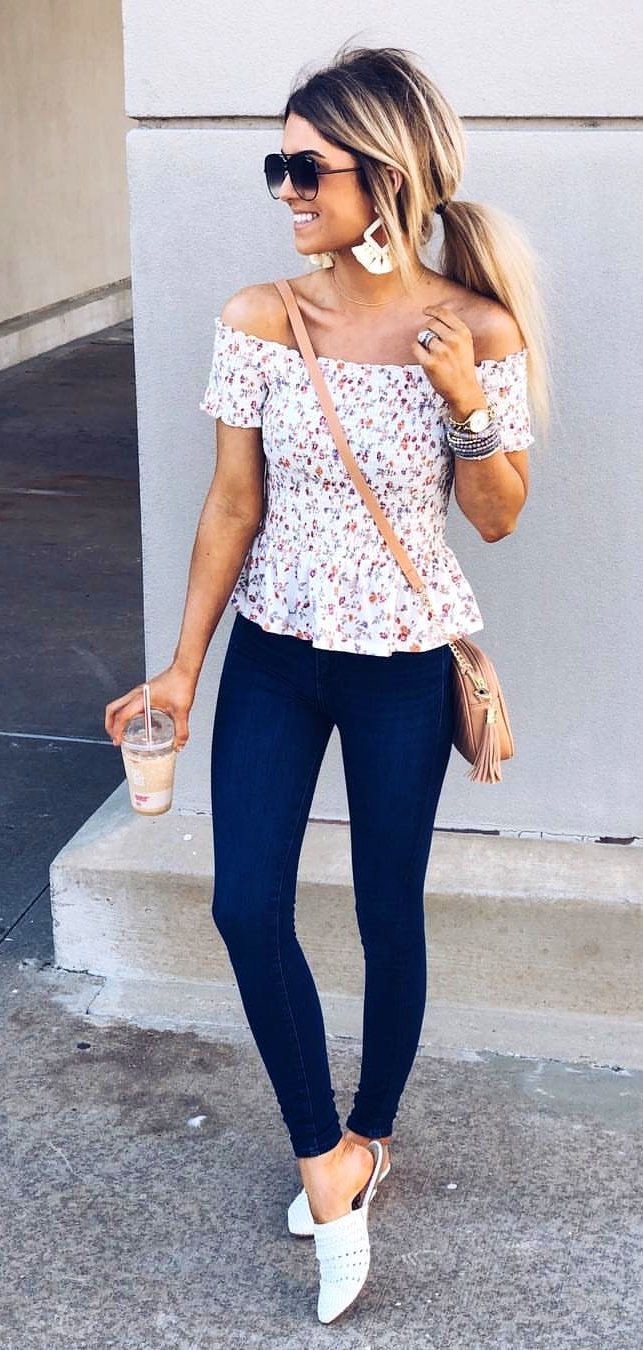 White and red off-shoulder shirt and blue denim fitted jeans.
