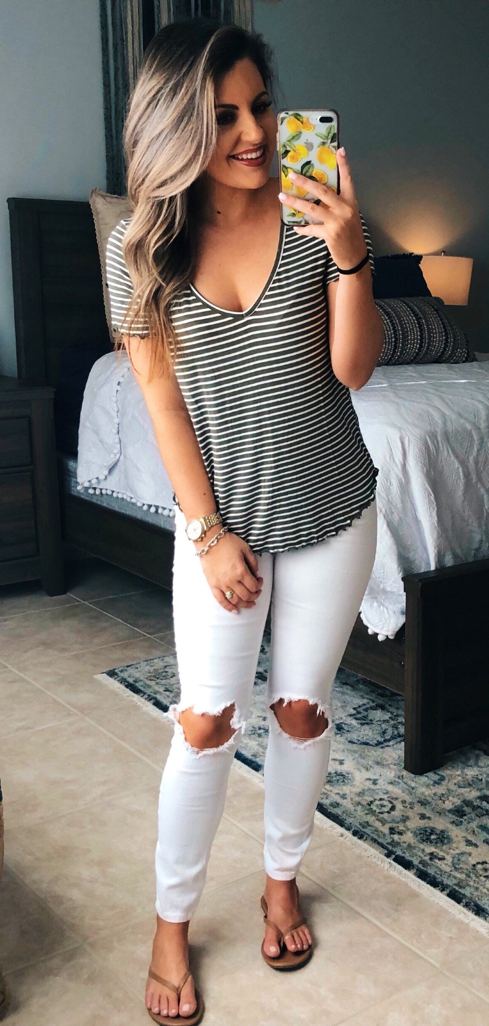 White distressed jeans, blcak and white striped blouse.