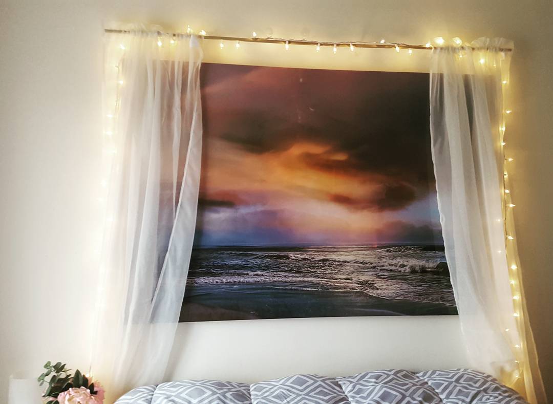 we hung up a large #ocean image and put curtains around it. I'm so in love! #diy #homeprojects #stringlights #bedroomdecor #beachdreaming #diyideas
