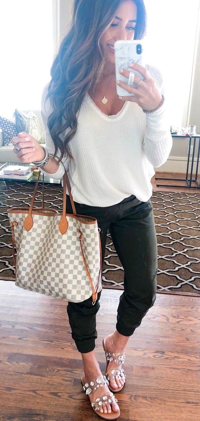 Black jogger and white scoop-neck long-sleeved shirt.