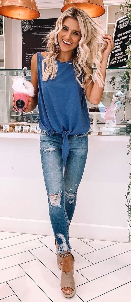 Distressed blue jeans and blue tank top.