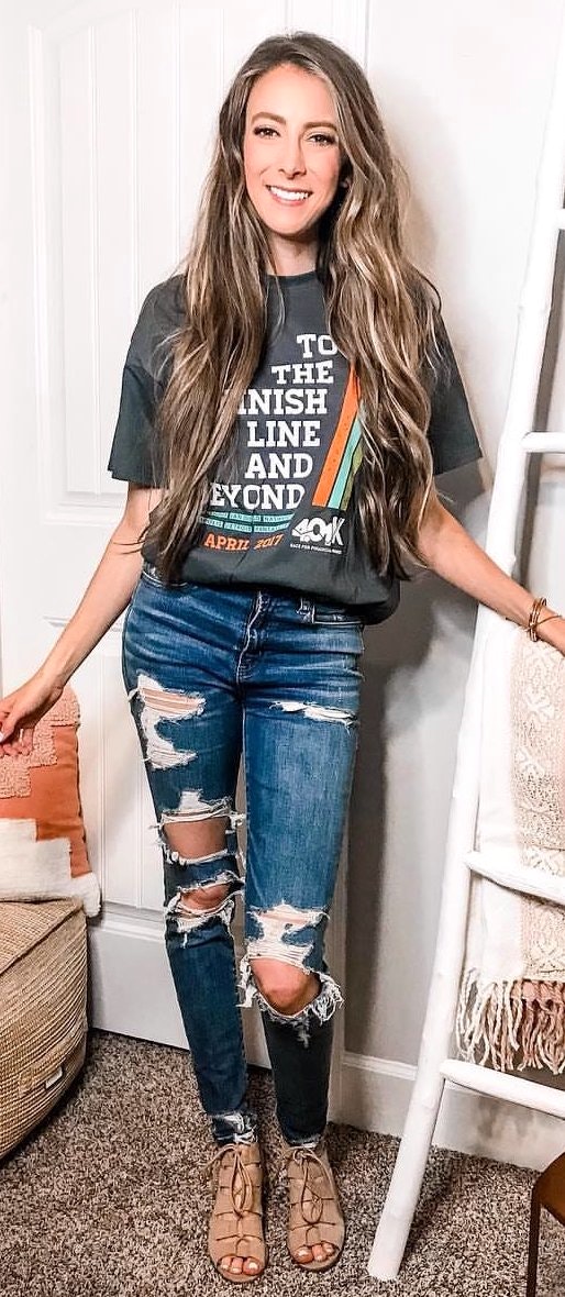 Distressed blue jeans and printed t-shirt.