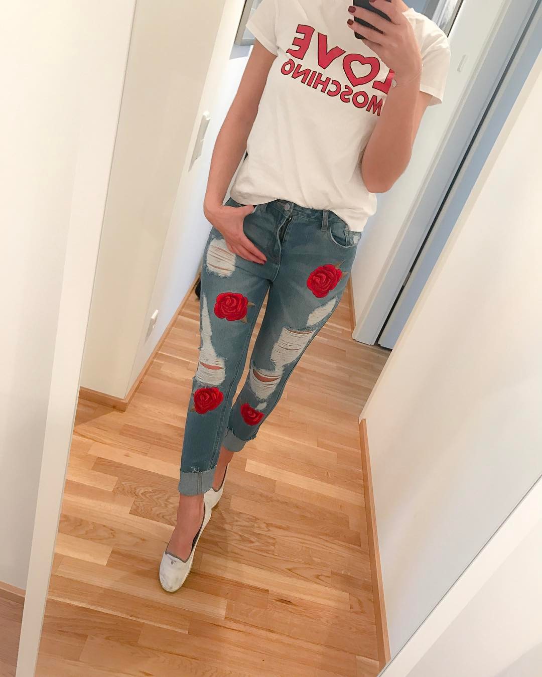 Graceful Red Roses On Ripped Jeans