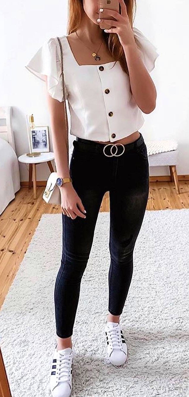 Scoop neck blouse and black fitted denim jeans.