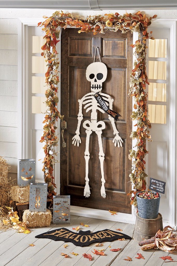 Get your haunted house ready with this spooky canvas skeleton door hanger