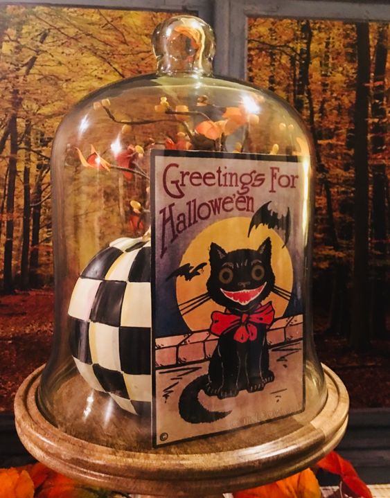 Halloween cloche with vintage card and black and white checked pumpkin.