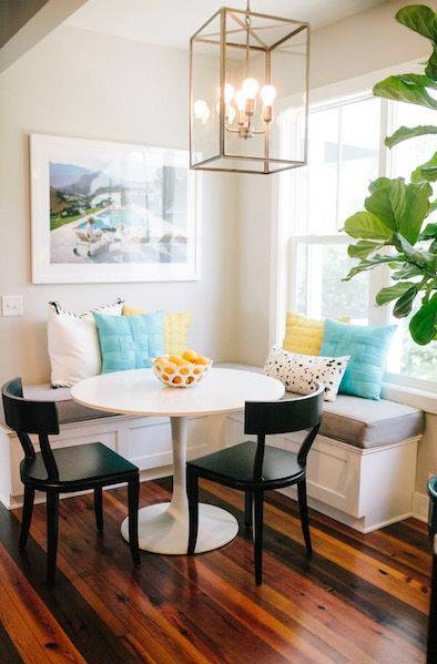 Swanky Breakfast Nook With Wooden Flooring, Round Table, Colored Cushion & Chandelier