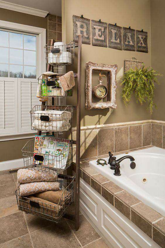 Use a LADDER & BASKETS for Bathroom STORAGE...Love this idea! What do you think
