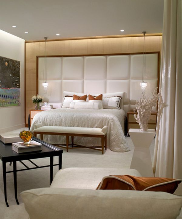 An oversized headboard with sconces can be a statement piece for the room