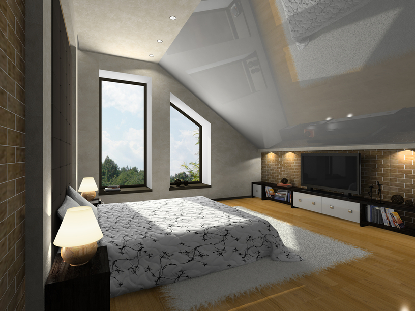 Bedroom with sloping ceiling, large windows, TV and light wood floor with one brick wall