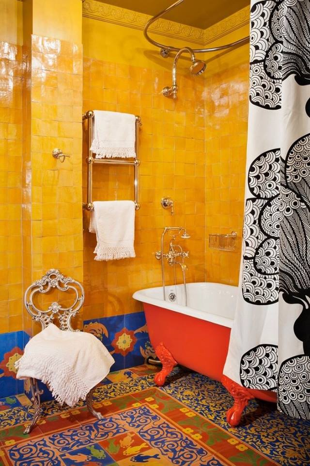 Creative Bohemian Bathroom With Yellow Wall, Orange Bath Tub & Colorful Flooring