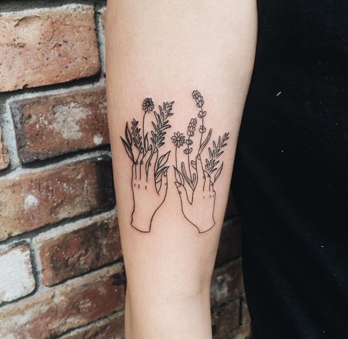 Hand with flowers line minimalist tattoo