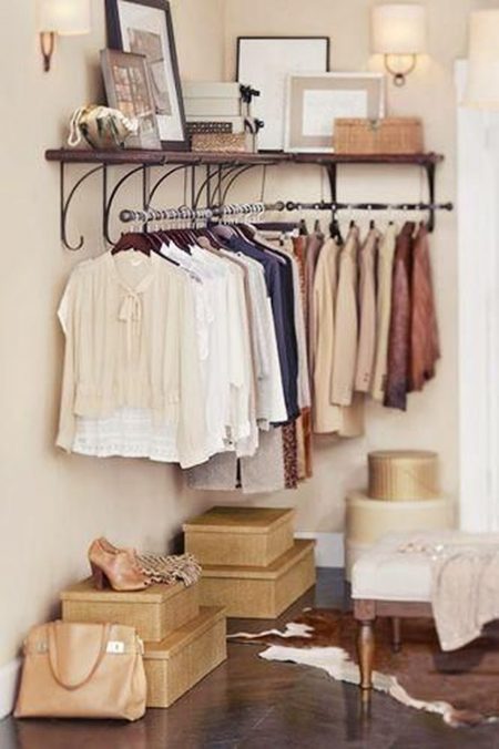 Hang a clothes rack in the corner.