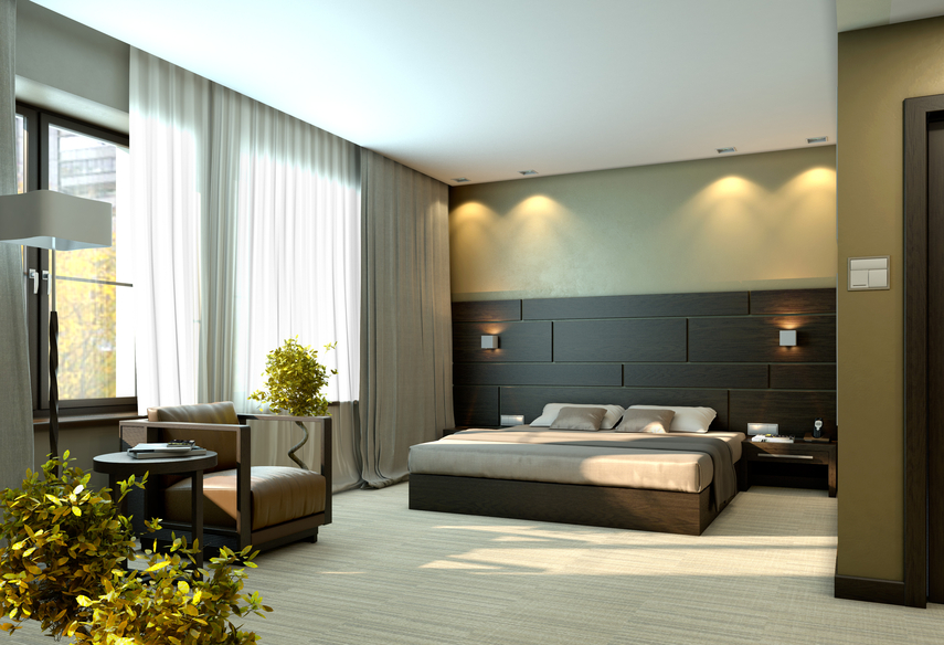 Large modern bedroom with black and green design and separate sitting area