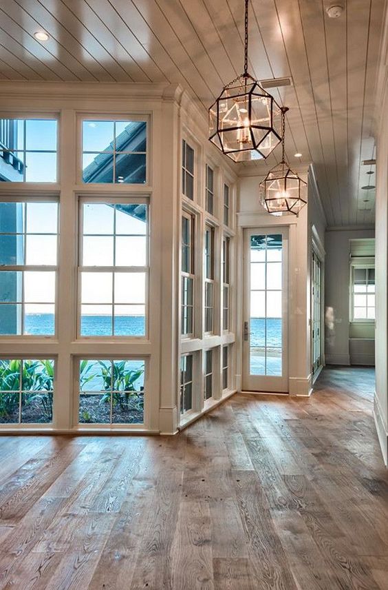 Morris Lanterns, floor to ceiling windows and reclaimed hardwood floors.