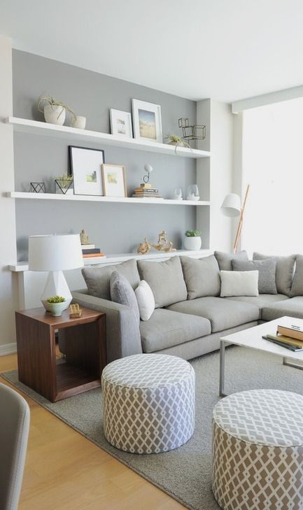 Scandinavian open concept living room with gray walls and light hardwood floors.