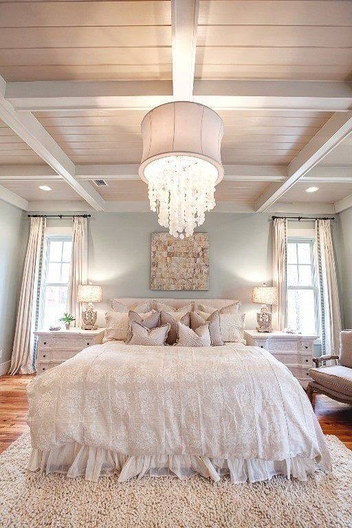 Tall Windows With Chandelier In Master Bedroom