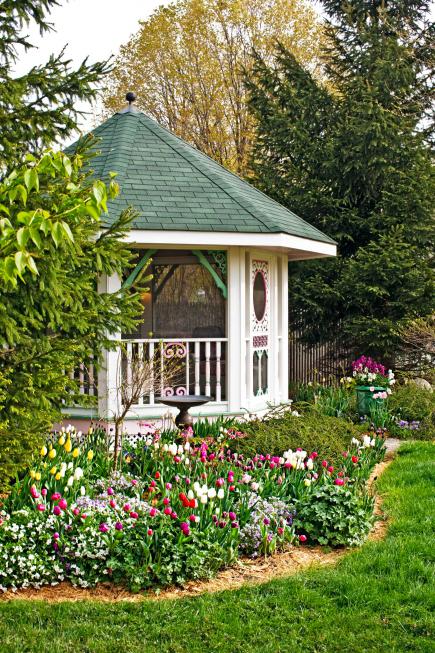 This sweet gazebo in a Grayslake, Illinois, yard adds whimsy via its color scheme and its gingerbread-type trim elements.