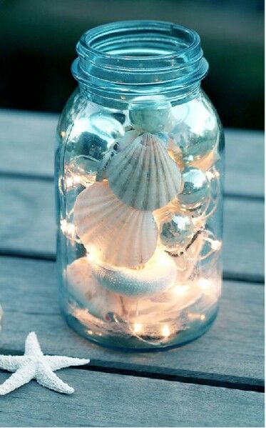 Twinkle tights and seashells in a mason jar cozy summer decor.