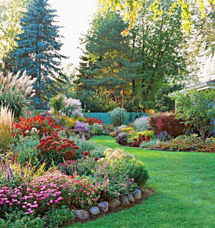 Undulating beds of low-maintenance perennials give a finished look to your landscape and decrease yard chores.