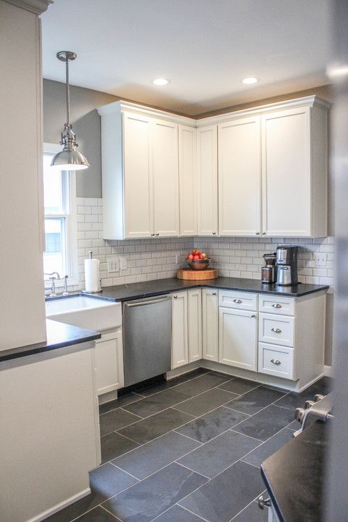 Modern Farmhouse Kitchen. Gray tile floors, white cabinets.