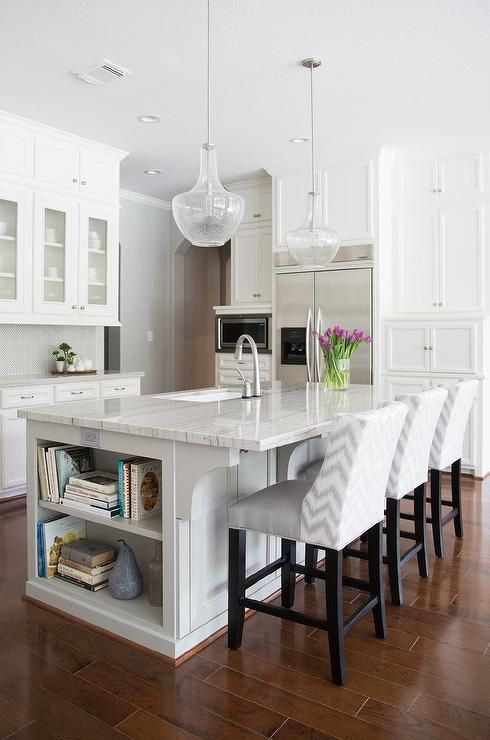 White and gray kitchen features white cabinets paired with New Macabus White Quartzite countertops