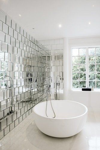 Bring in a lot of awesome factor to your bathroom with a mirrored wall.