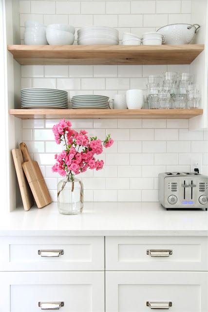 Cheer up your kitchen with a bunch of perky and bright flowers displayed in a glass vase.