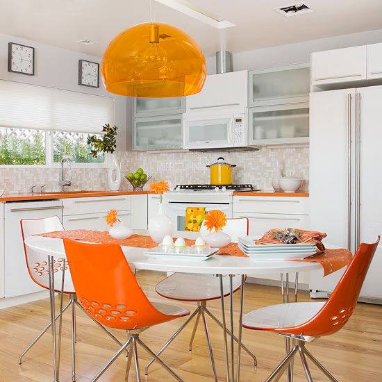 Perky orange is enough to pick up glaring white kitchens.