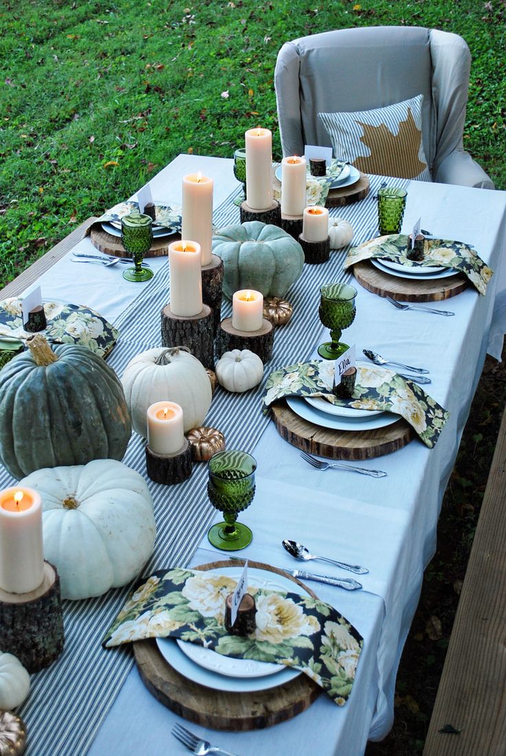 Pumpkins, gourds and candles on tree stumps would be a great