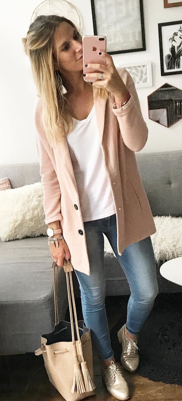 women's beige cardigan, white v-neck top and faded blue jeans