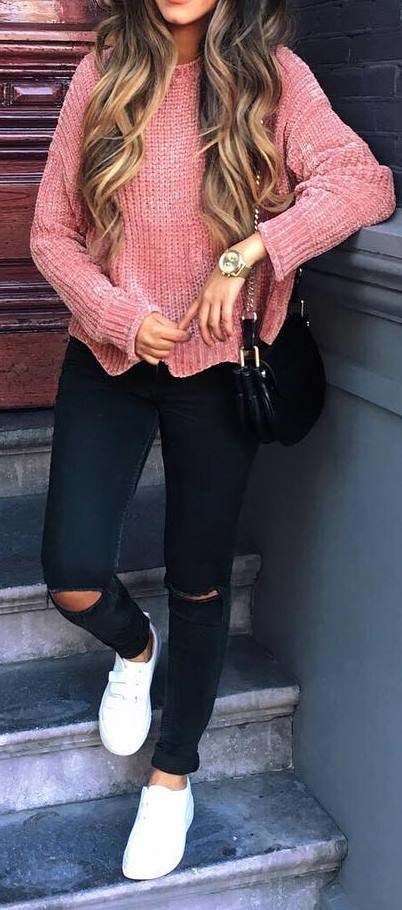 women's pink crewneck sweater and distressed black jeans