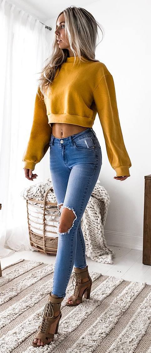 yellow sweatshirt + ripped jeans + boots