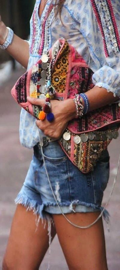 Boho chic crochet embellished peasant blouse top with modern hippie cut off denim blue jean shorts and gypsy style coin clutch purse.