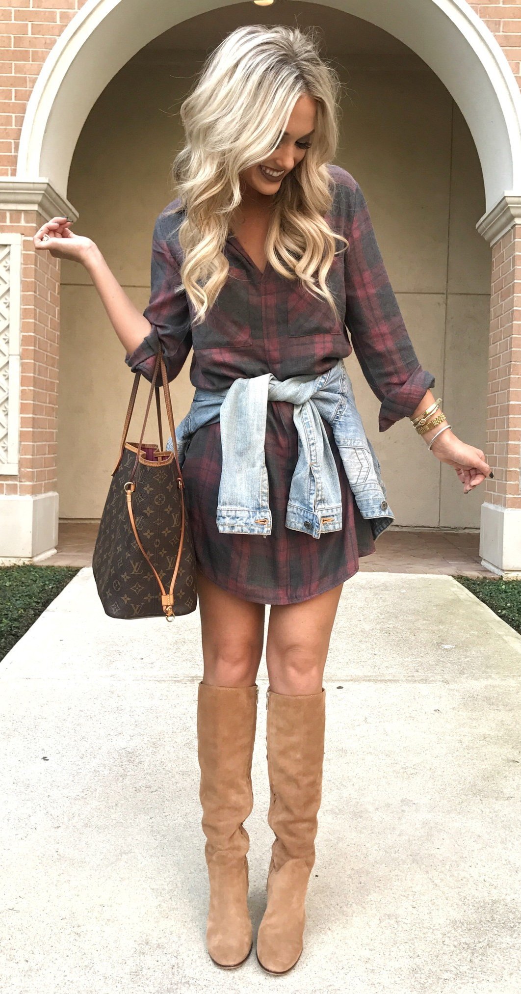 women's black and red plaid button-up long-sleeved mini dress, blue denim jacket, and pair of brown leather knee-high boots outfit