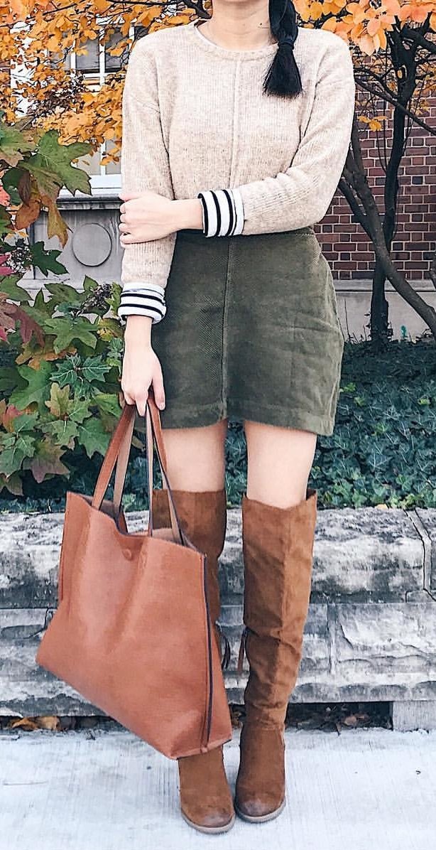 women's brown long-sleeved sweater; gray denim skirt; brown leather knee high boots; and brown leather tote bag