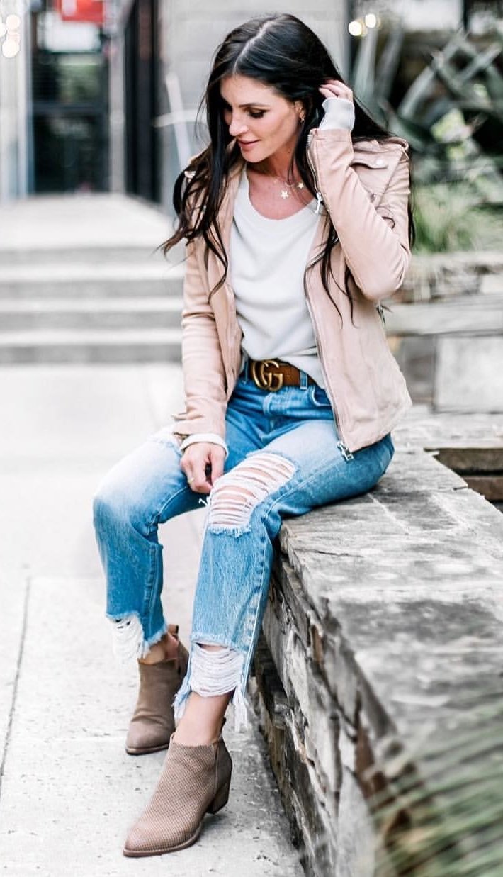 women's distressed jeans, brown zip-up coat, booties and t-shirt attire