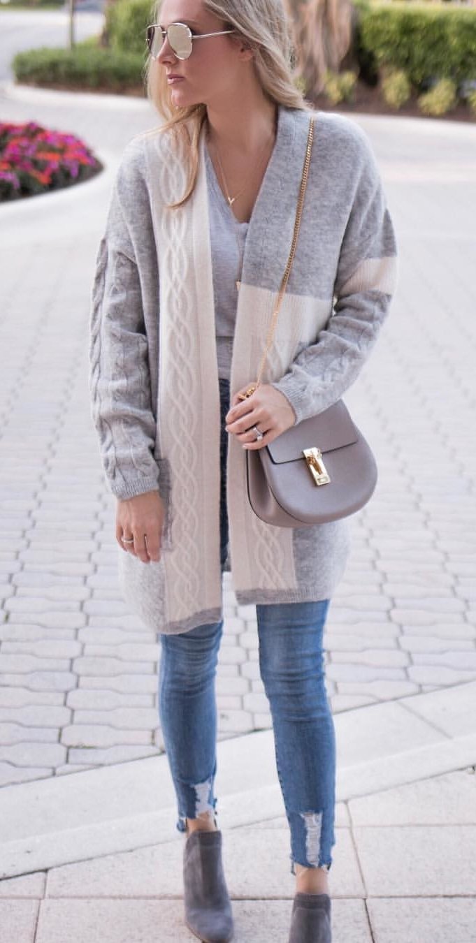 women's heather gray cardigan and distressed blue-washed jeans with pair of brown leather mid-calf boots