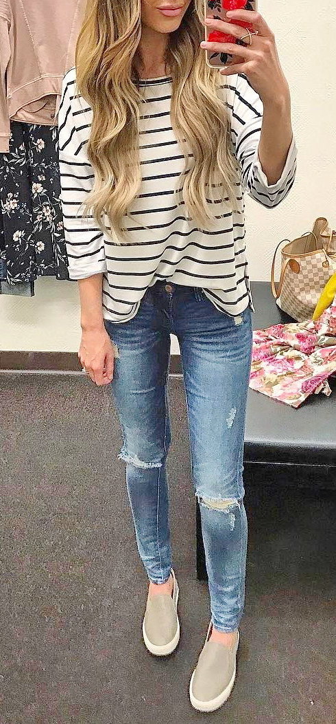 women's white and black stripe long-sleeved shirt and blue denim jeans