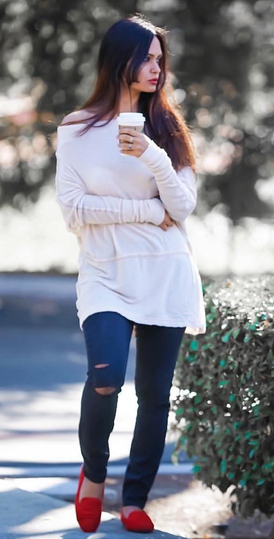 women's white off shoulder sweatshirt and distressed blue jeans