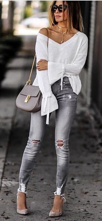 women's white v-neck long-sleeved top with gray distressed jeans