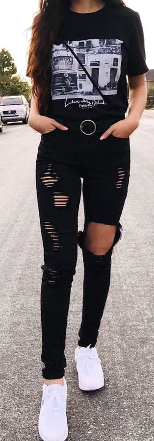 Black crew-neck shirt and distressed jeans.