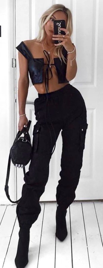 Black leather crop top with black pants and pair of black heeled booties outfit.