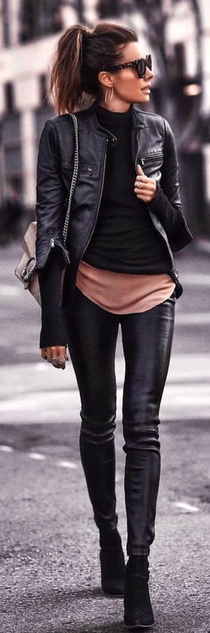 Black leather zip-up jacket and black skinny jeans.