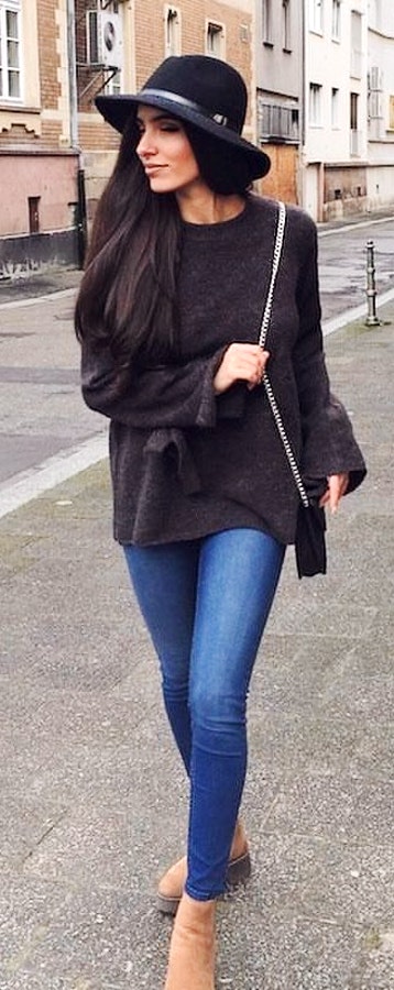Black long-sleeved shirt and blue-washed fitted jeans