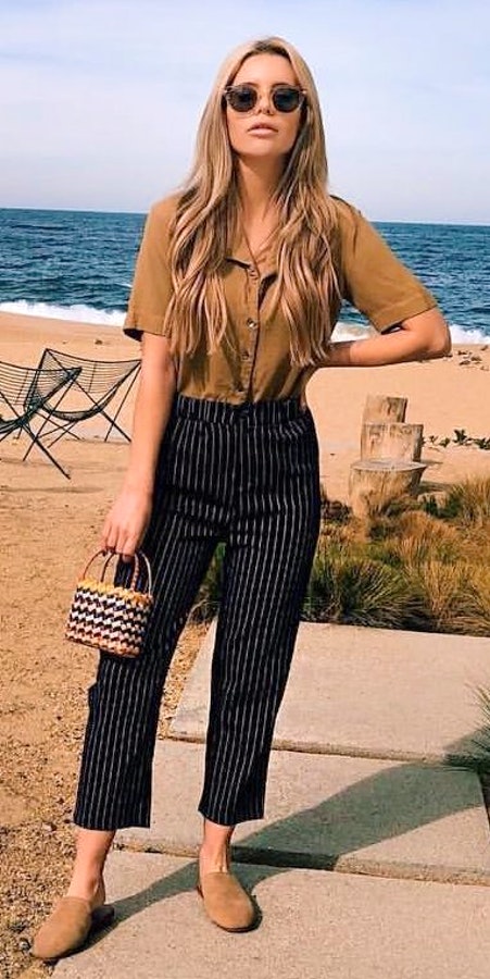 Brown collared short-sleeved button-up shirt and black striped pants. Pic originally posted by brittrix