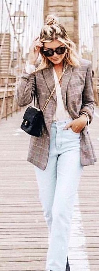Gray and white tattersall coat and gray jeans